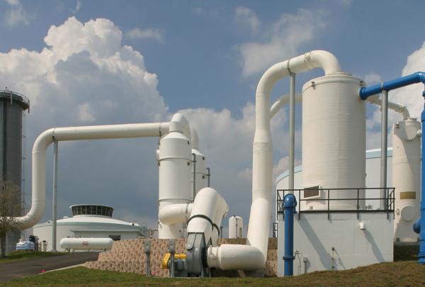 Large white storage tanks and piping outside the SMRU Water Treatment Facility